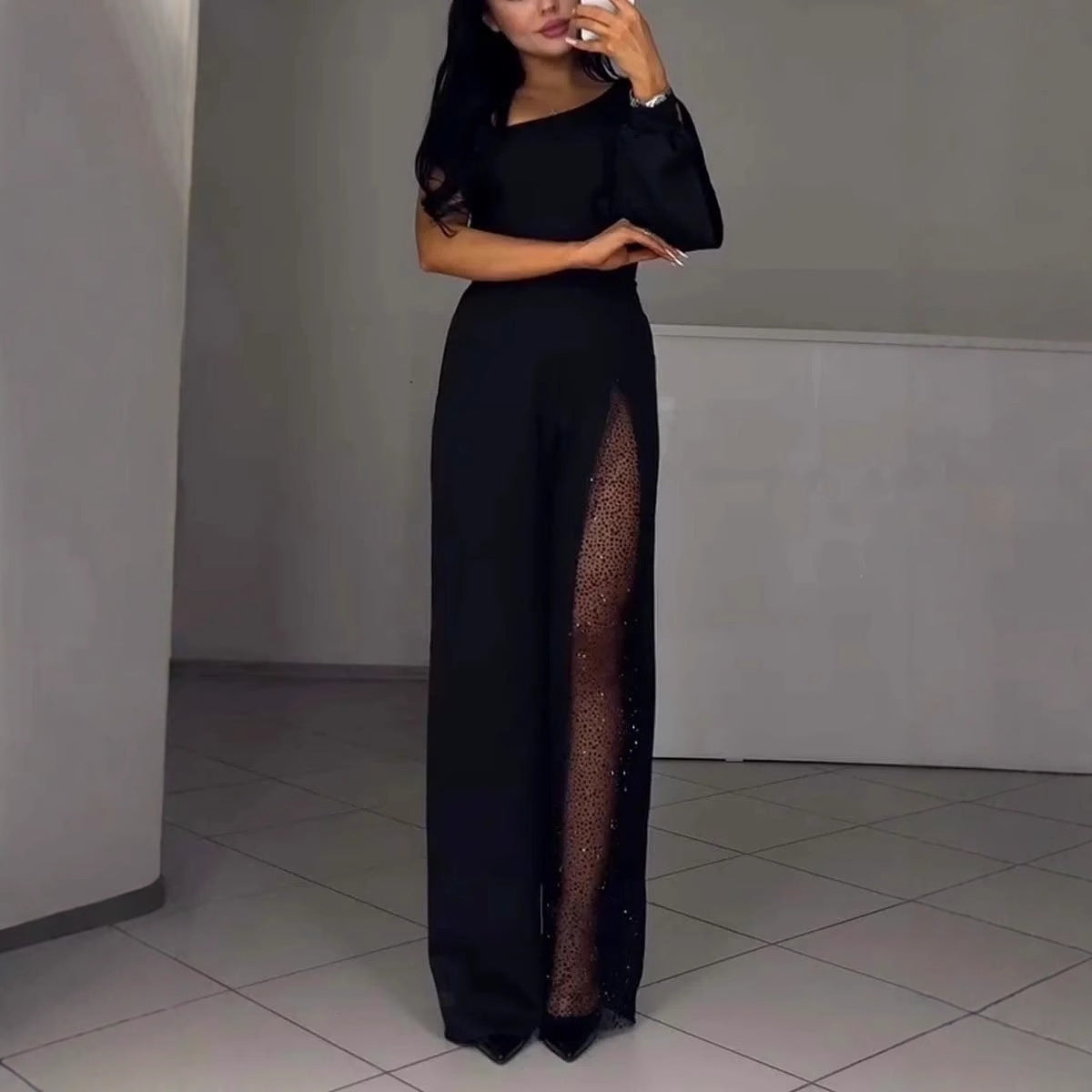 Serena Villanueva | Sort jumpsuit med mesh-pailletpanel og lange ærmer til kvinder