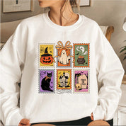 Halloweenský svetr Cauldron Cat | s koláží strašidelných razítek